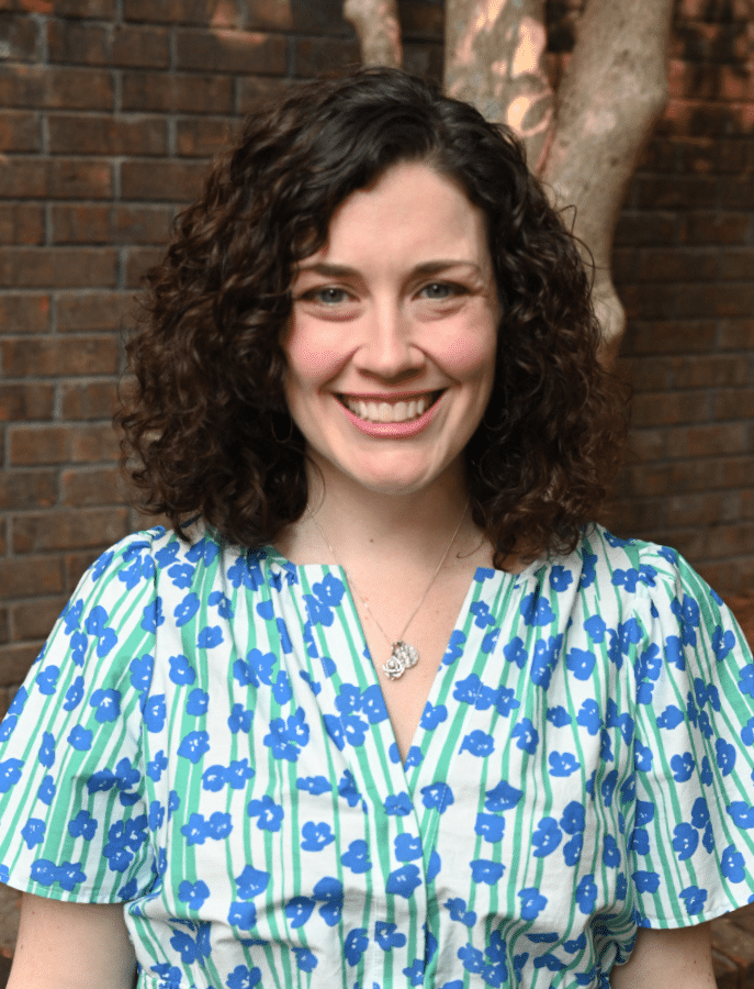 headshot of a woman posing in front of elevated landscaping